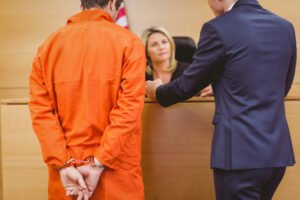 Defendant and attorney talking with judge during the arraignment