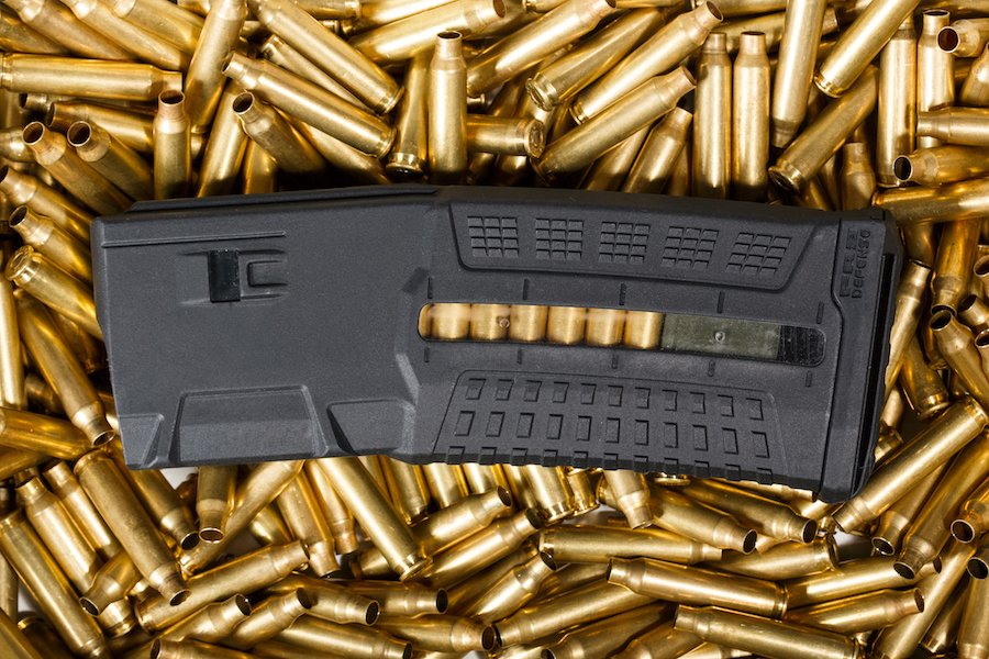 High capacity magazine against pile of bullets