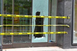 Broken glass window on retail store after organized retail theft