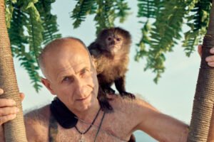 A man with a monkey on his shoulder